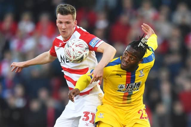 Paul Downing battles Michy Batshuayi for the ball during Doncaster's FA Cup fifth-round tie against Crystal Palace. Picture: Michael Regan/Getty Images