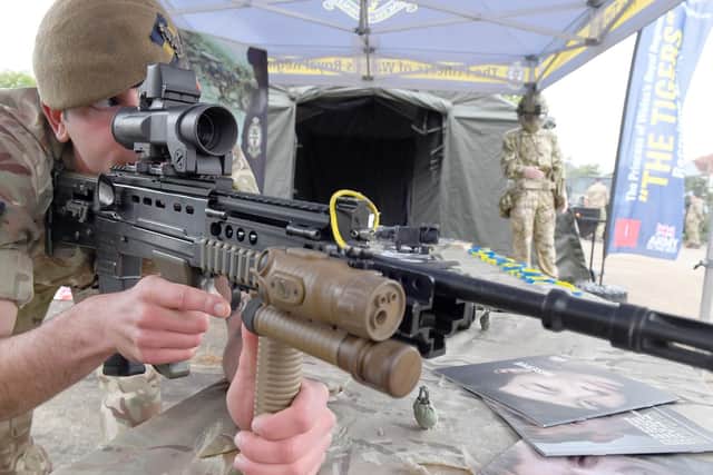 Private Freddie Morley, based with 'The Tigers' - PWRR2, looks down the sights of a L85A2 weapon.