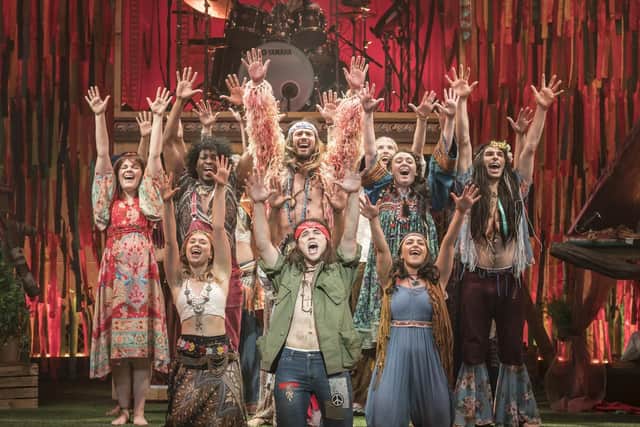The cast of Hair The Musical, with Paul Wilkins kneeling, front-centre. Picture by Johan Persson
