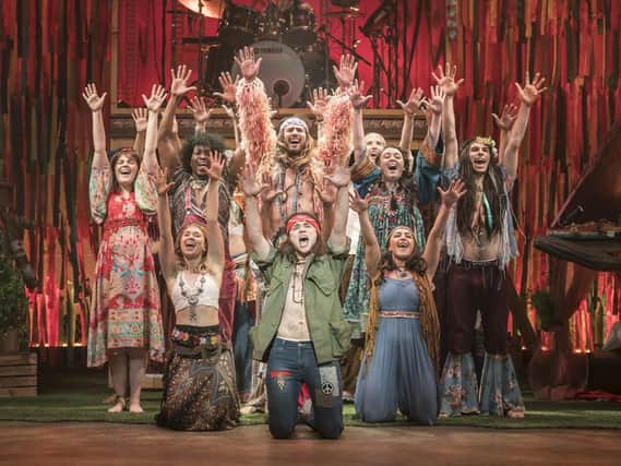 The cast of Hair The Musical, with Paul Wilkins kneeling, front-centre. Picture by Johan Persson