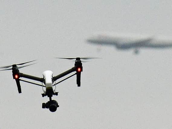 Drone flying in Hanworth Park in west London, as a British Airways 747 plane prepares to land at Heathrow Airport. Picture: John Stillwell/PA Wire