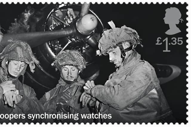 Stamp featuring paratroopers synchronising their watches during the D-Day landings, one of the new stamps that will be issued to commemorate the 75th anniversary of D-Day. Picture: Royal Mail/PA Wire