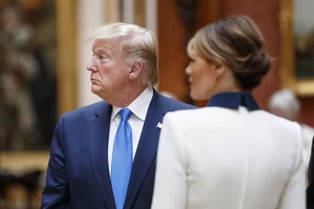 US President Donald Trump with his wife Melania view a special exhibition in the Picture Gallery of items from the Royal Collection of historical significance to the US, following a private lunch at Buckingham Palace in London. Tolga Akmen/PA Wire