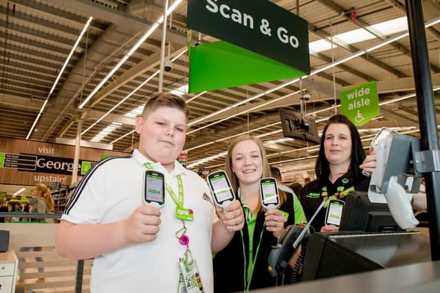 Finley with colleagues Sarah Twine and Dani Dean at Asda in Portsmouth. Picture: Robin Jones/ Digital South