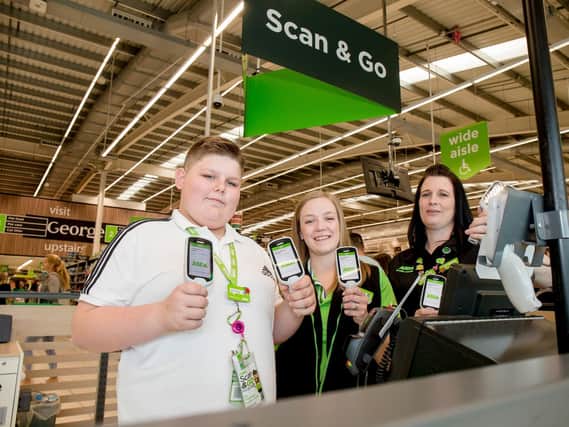 Finley with colleagues Sarah Twine and Dani Dean at Asda in Portsmouth. Picture: Robin Jones/ Digital South