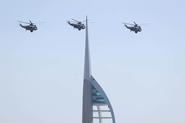 Three Royal Navy Sea King helicopters fly past the Spinnaker tower in Portsmouth, as they approach HMS Sultan ahead of their retirement from military service.
 PRESS ASSOCIATION Photo. Picture date: Wednesday September 26, 2018. See PA story DEFENCE SeaKing. Photo credit should read: Andrew Matthews/PA Wire