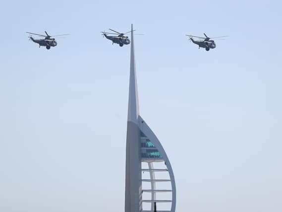 Three Royal Navy Sea King helicopters fly past the Spinnaker tower in Portsmouth, as they approach HMS Sultan ahead of their retirement from military service.
 PRESS ASSOCIATION Photo. Picture date: Wednesday September 26, 2018. See PA story DEFENCE SeaKing. Photo credit should read: Andrew Matthews/PA Wire