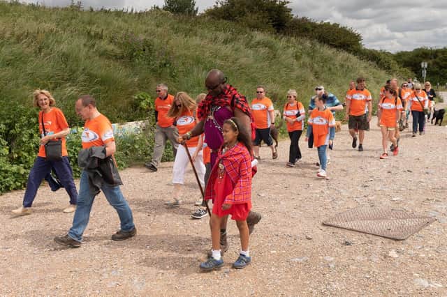 Boniface, centre, sets off on the walk with his daughter - alongside Sue Tinney, far-left. Picture: Keith Woodland (090619-23)