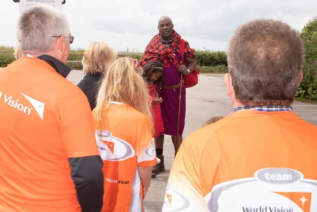 Boniface speaks to the walkers about how he has benefited from World Visions water programme.Picture: Keith Woodland (090619-5)