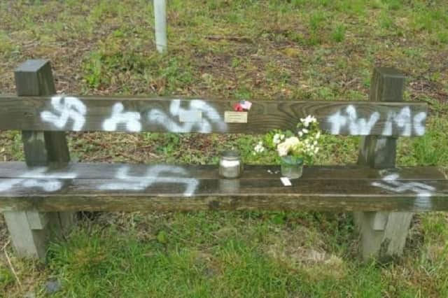 A commemorative bench which has been spray painted with a swastika in Twyford Woods, Lincolnshire, a site which was used as an airfield in the Second World War for aircraft to take off for Normandy ahead of D-Day. Picture: Lincolnshire Police/PA Wire