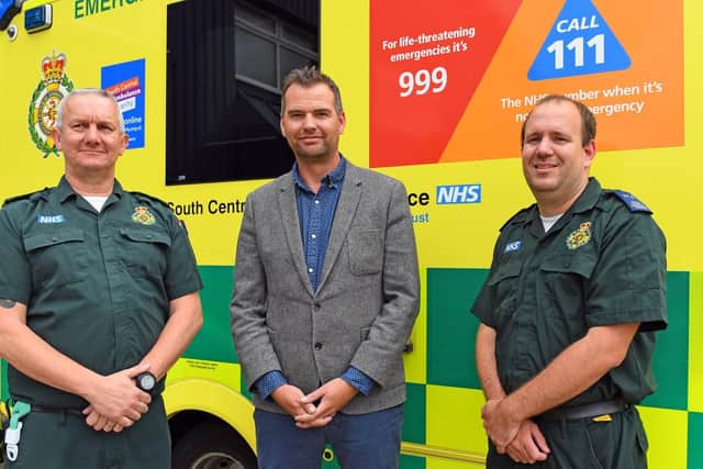 SCAS Technical Team Leader Dave Gardiner, left, with SCAS Emergency Care Assistant Chris Addoo who responded to an emergency call when Jamie (centre) collapsed just 400 metres from the finish line of the 2018 Great South Run on Southsea seafront Picture: Malcolm Wells (190610-2170)