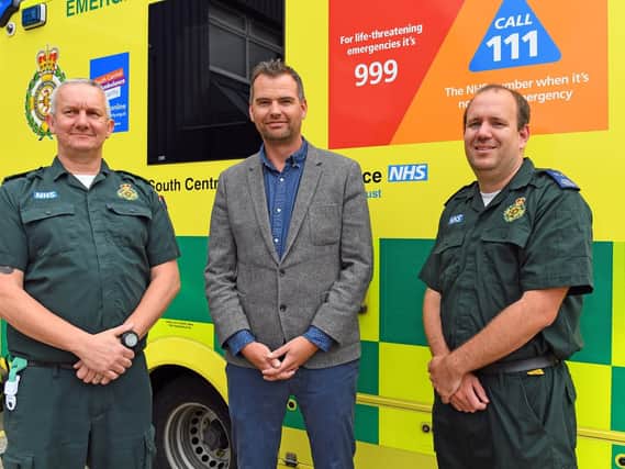 SCAS Technical Team Leader Dave Gardiner, left, with SCAS Emergency Care Assistant Chris Addoo who responded to an emergency call when Jamie (centre) collapsed just 400 metres from the finish line of the 2018 Great South Run on Southsea seafront Picture: Malcolm Wells (190610-2170)