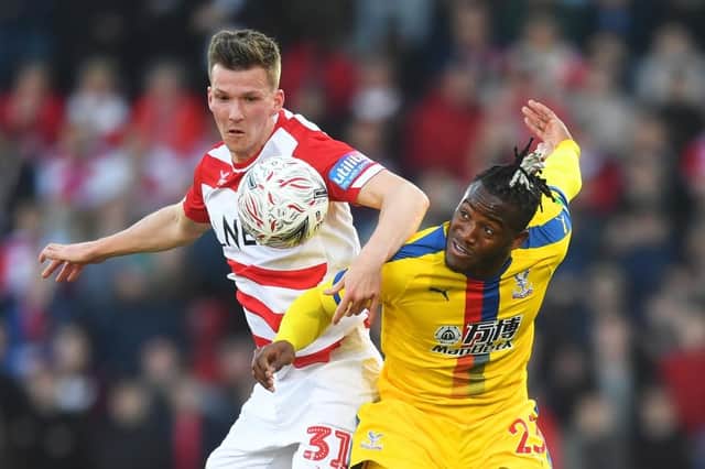 Doncaster boss Grant McCann fears losing out in the battle with Pompey for Paul Downing (left). Picture: Michael Regan/Getty Images