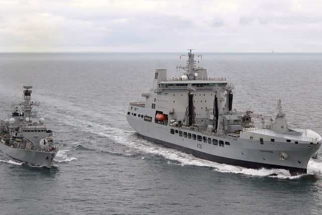 Royal Fleet Auxiliary Tidespring, right, sailing next to the Type 23 frigate HMS Sutherland during a replenishment at sea off England's south coast.