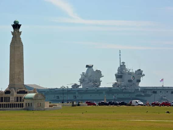 Royal Navy aircraft carrier HMS Queen Elizabeth sails past the Portsmouth Naval Memorial on Southsea Common, after sailing out of Portsmouth Harbour for sea trials. Picture: Ben Mitchell/PA Wire