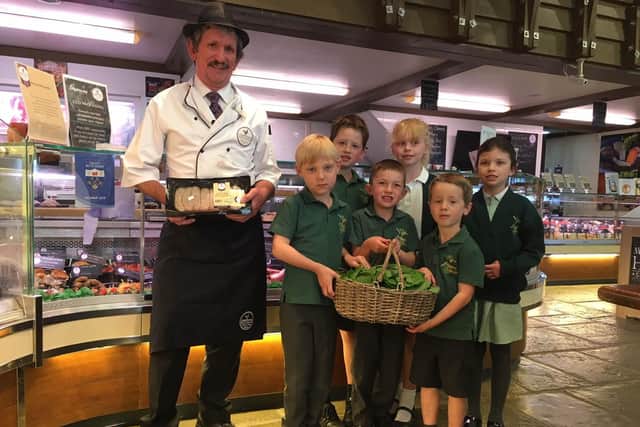 Butcher Bob Harding takes delivery of a fresh batch of Jack by the Hedge from Wicor Primary school pupils.