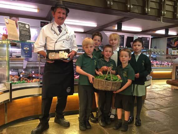 Butcher Bob Harding takes delivery of a fresh batch of Jack by the Hedge from Wicor Primary school pupils.