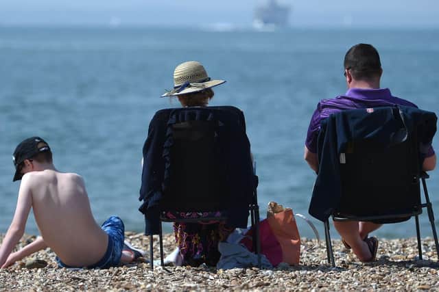 Sunbathers enjoy the warm weather on Southsea beach. Picture: Andrew Matthews/PA Wire