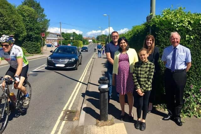 Ruby Lloyd, aged 11, shows MP Suella Braverman where she thinks a crossing should go on the Warsash Road.
