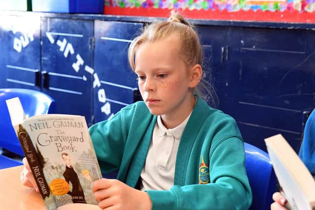 Olivia Brewer, 11, studies the early pages of The Graveyard Book
Picture: Malcolm Wells (190703-3485)