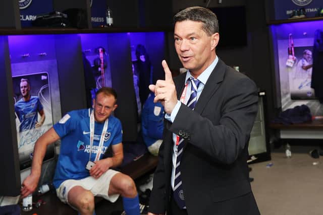 Matt Clarke listens as Mark Catlin addresses Pompey's triumphant dressing room following their Checkatrade Trophy victory. Picture: Joe Pepler