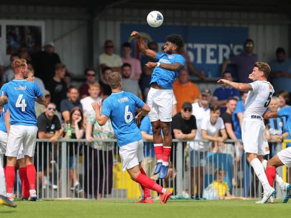 Ellis Harrison rises highest during Saturday's 2-1 victory at the Hawks. Picture: Dave Haines/Portsmouth News