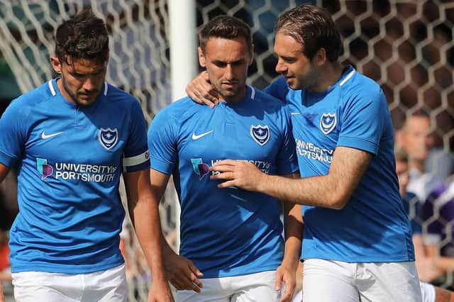 Brandon Haunstrip, centre, is congratulated by Gareth Evans, left, and goalscorer Brett Pitman after assisting Pompey's winner against the Hawks. Picture: Dave Haines