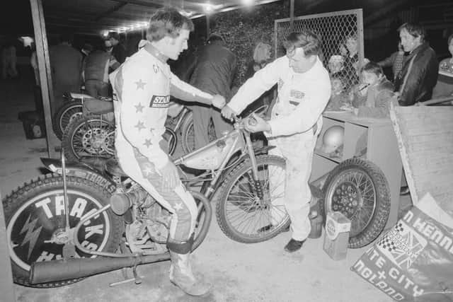 Gordon Kennett and a mechanic prepare his bike for a race in 1970. Picture: Evening Standard/Hulton Archive/Getty Images