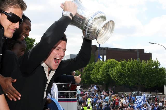 David Nugent hoists the FA Cup aloft during the open-top bus parade in 2008. Picture: Joe Pepler/ Portsmouth FC