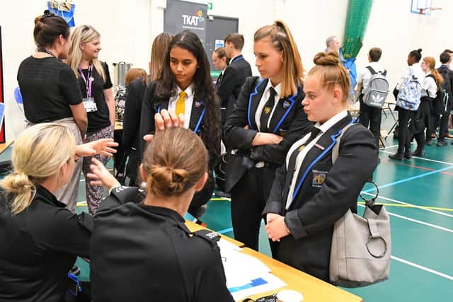 PC Amy Ronchetti from the Military Defence Police and PC Steph Bavin from Hampshire Police chat to 15 year olds Gabrielly Silva, Demi Richmond and Daisy Reid. Picture: Malcolm Wells (190717-4052)