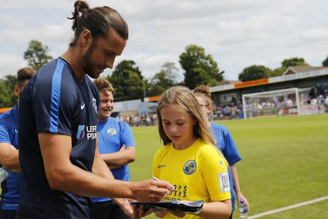 Christian Burgess signs autographs ahead of Pompey's 2-1 friendly victory over the Hawks. Picture: Dave Haines/Portsmouth News