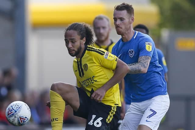 Marcus Harness holds off Tom Naylor during Pompey's win over Burton in April. Picture: Daniel Chesterton/phcimages.com
