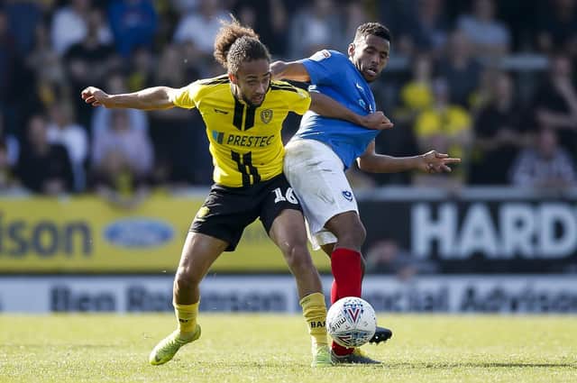 Marcus Harness battles Nathan Thompson for the ball during Pompey's win at Burton in April. Picture: Daniel Chesterton/phcimages.com
