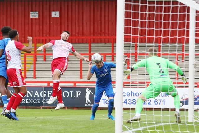 Ronan Curtis heads home Jamal Lowe's cross to earn Pompey a 1-0 victory at Stevenage. Picture: Joe Pepler