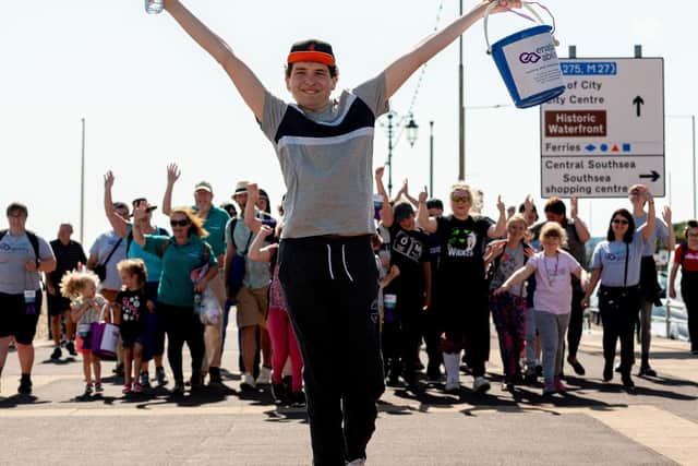 Harley Salter approaches South Parade Pier with his family and friends supporting behind. Picture: Vernon Nash (200719-002)