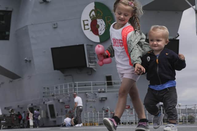 Youngsters Olivia Wise holds her brother, Kaiden's hand on the flight deck of HMS Queen Elizabeth during Portsmouth Families Day. Photo: LPhot Unaisi Luke