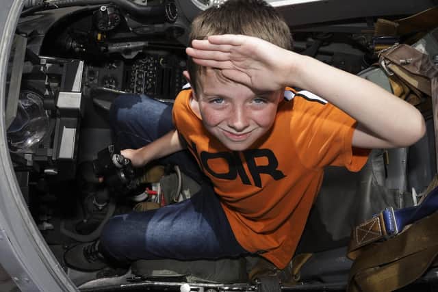 Yes sir! Mikey Copeman pictured saluting in a Harrier cockpit simulator on display set up in front of HMS Dragon during the Portsmouth Families Day held. Photo: LPhot Unaisi Luke