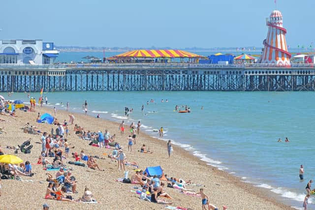 It was very hot in Southsea, Hampshire, yesterday as people took the opportunity to swim and sunbath. South Parade Pier is in the background. Picture: Malcolm Wells (190724-3277)