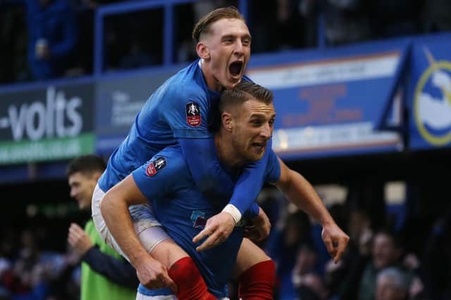 Lee Brown and Ronan Curtis celebrate Joel Lynch's scores own goal during Pompey's 1-1 FA Cup draw with QPR. Picture: Joe Pepler