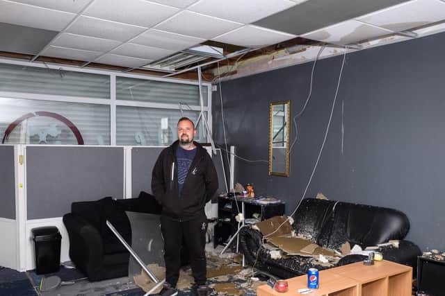 Pictured is: Danny Silvester amongst the damage caused to his tattoo parlour by the fire in the above flat.
Picture: Keith Woodland (270719-4)