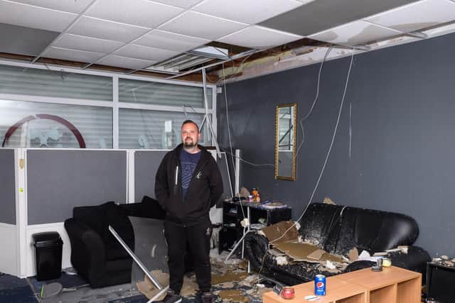 Pictured is: Danny Silvester amongst the damage caused to his tattoo parlour by the fire in the above flat.

Picture: Keith Woodland (270719-4)