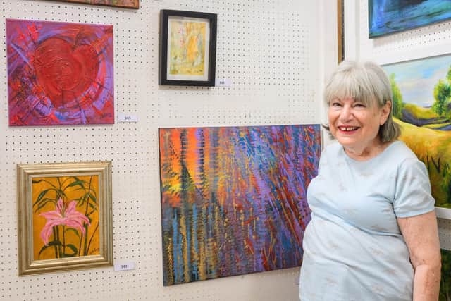 Pictured is: Victoria Levy with some her work at the exhibition.
Picture: Keith Woodland (270719-13)