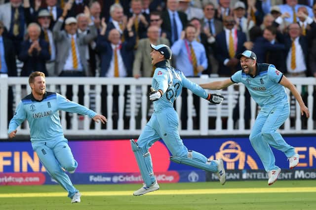 Liam Dawson, left, celebrates England's super-over triumph over New Zealand with Jos Buttler, centre, and Mark Wood. Picture: Mike Hewitt/Getty Images