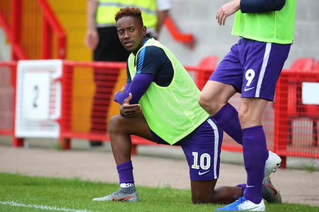 Jamal Lowe warms up on the sidelines during Pompey's pre-season game at Crawley Picture: Joe Pepler