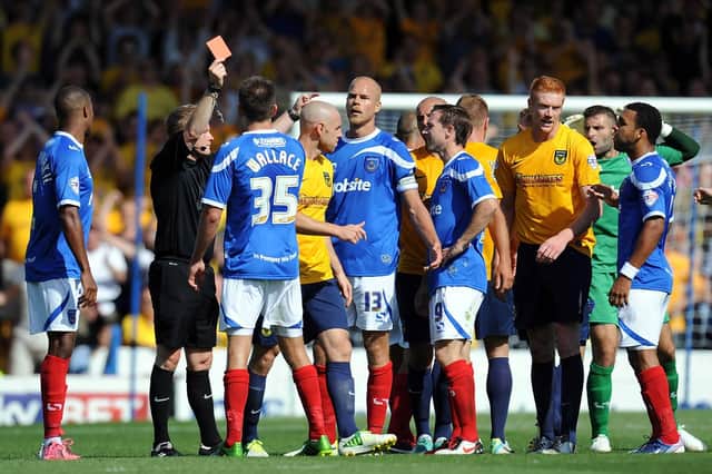Portsmouth's Johnny Ertl (number 13) is shown the red card by the referee during the Sky Bet League Two match at Fratton Park, Portsmouth.