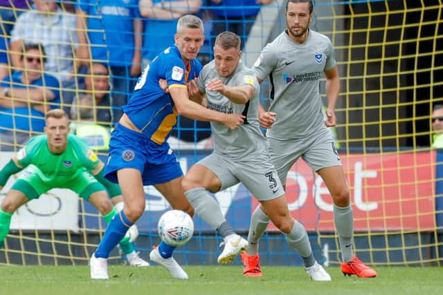Shrewsbury Town forward Steve Morison battles with Pompey defender Lee Brown. Picture: Simon Davies