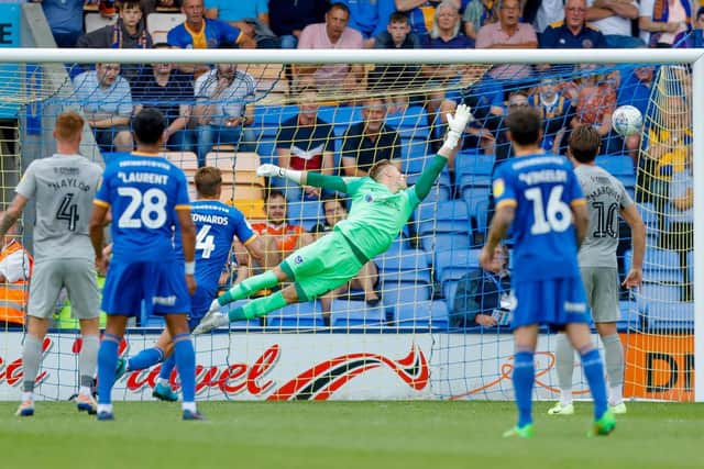 Shrewsbury midfielder Ryan Giles (11) fires home past Craig MacGillivray (1)