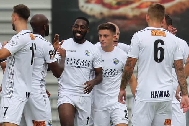 Roarie Deacon, centre, is congratulated by his Hawks team-mates after opening the scoring against Welling United Picture: Dave Haines