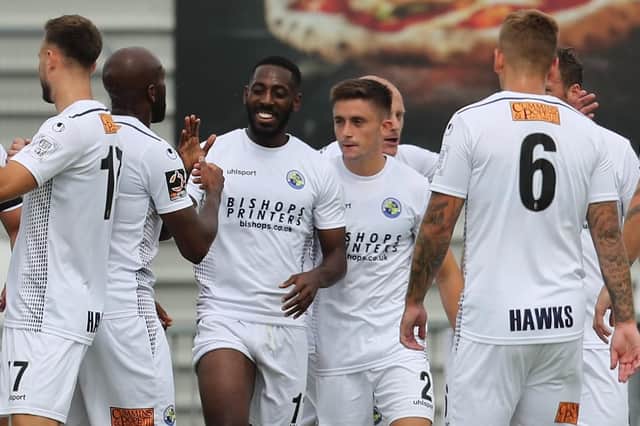 Roarie Deacon, centre, is congratulated by his Hawks team-mates after opening the scoring against Welling United   Picture: Dave Haines