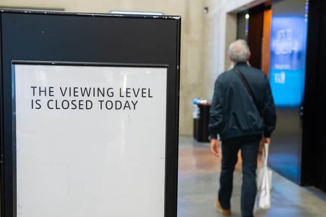 A member of the public walks past a closed sign at the Tate Modern art gallery in London, following the arrest of a 17-year-old male on suspicion of attempted murder after a six-year-old boy was thrown from the tenth floor viewing platform on Sunday. Picture: Dominic Lipinski/PA Wire